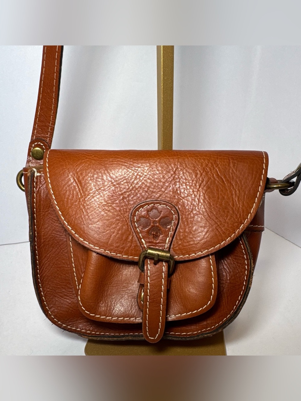Patricia Nash Bonella Mini Crossbody Saddle Bag in their signature tan/cognac